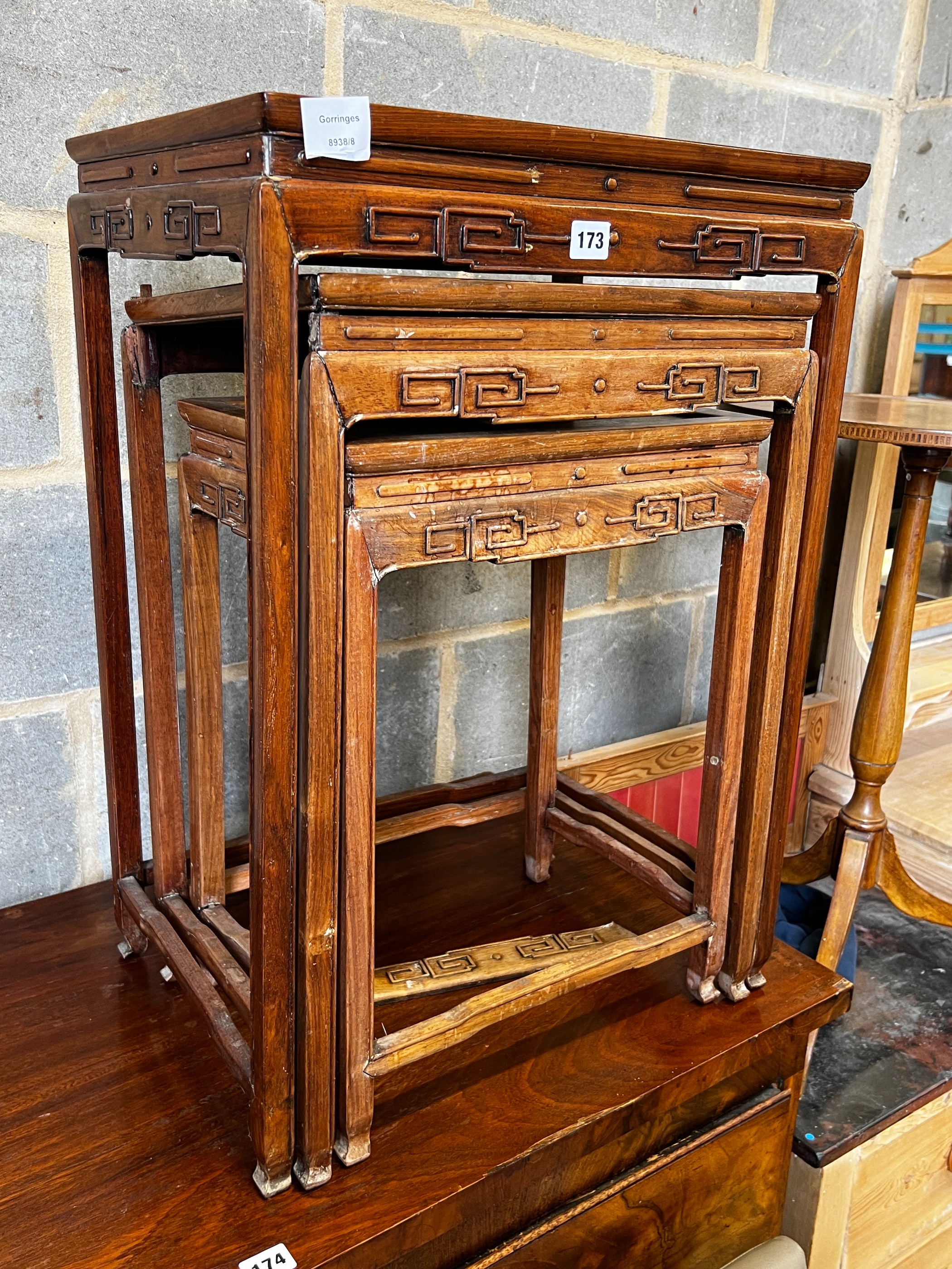 A nest of three Chinese rectangular hardwood tea tables, width 49cm, depth 35cm, height 59cm